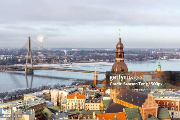 cityscape with old town, river and bridge, riga, latvia - riga latvia stock pictures, royalty-free photos & images