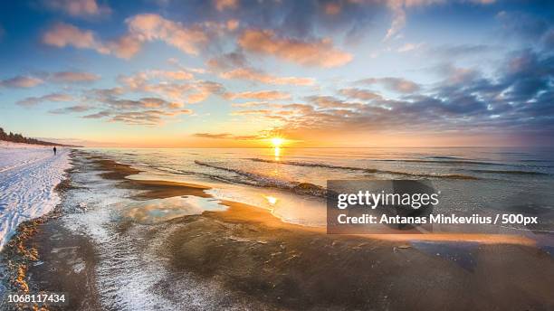 sunset over sea in winter - baltic states stock pictures, royalty-free photos & images