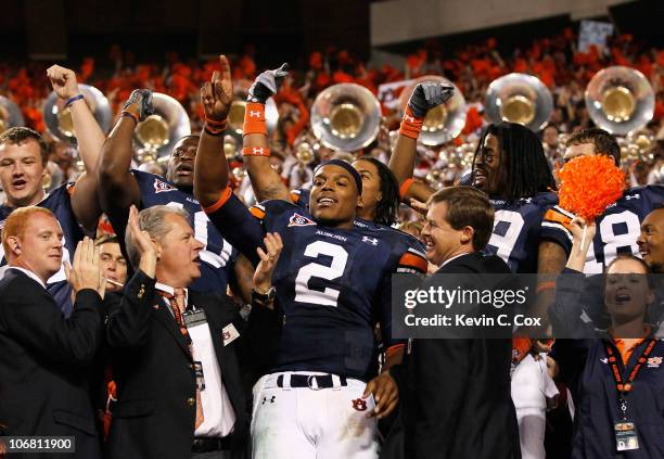 Quarterback Cameron Newton of the Auburn Tigers celebrates with fans after their 49-31 win over the Georgia Bulldogs at Jordan-Hare Stadium on...