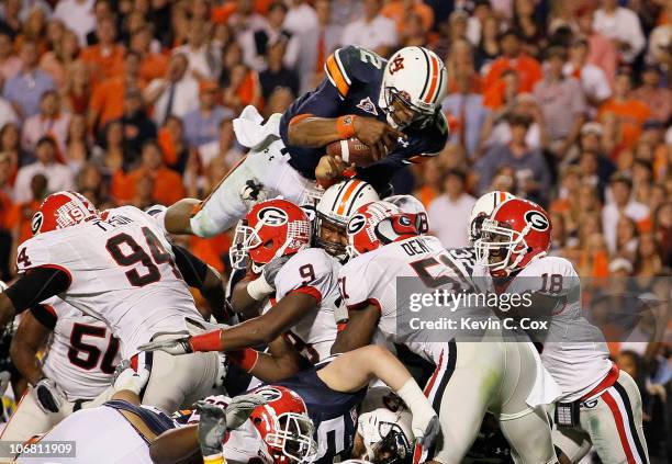 Quarterback Cameron Newton of the Auburn Tigers dives across the defense for a touchdown against the Georgia Bulldogs at Jordan-Hare Stadium on...