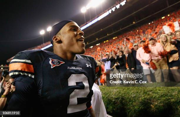 Quarterback Cameron Newton of the Auburn Tigers celebrates with fans after their 49-31 win over the Georgia Bulldogs at Jordan-Hare Stadium on...