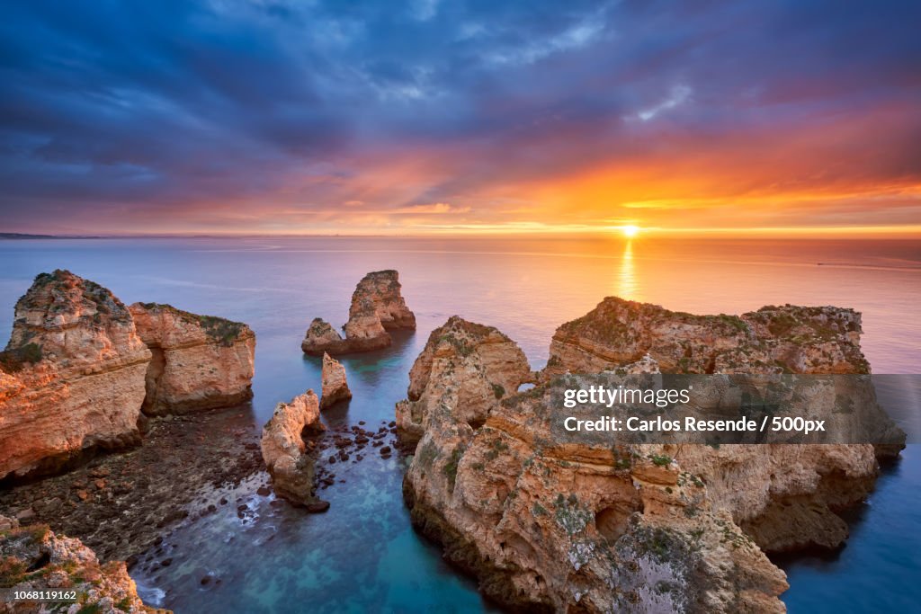 Beautiful sunrise at sea and rock formation in foreground