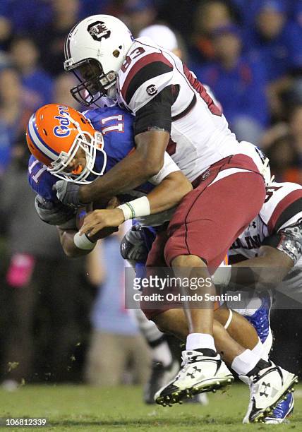 Florida quarterback Jordan Reed is tackled by South Carolina defensive end Cliff Matthews during the first half of the Gators game against the...