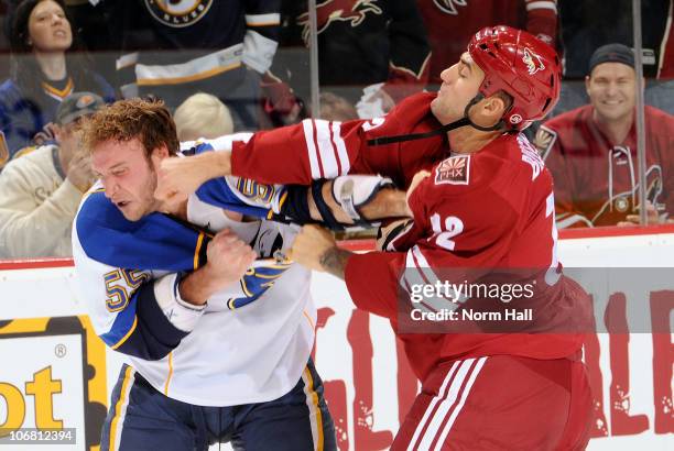 Paul Bissonnette of the Phoenix Coyotes gets in a right hook on Cam Janssen of the St. Louis Blues on November 13, 2010 at Jobing.com Arena in...