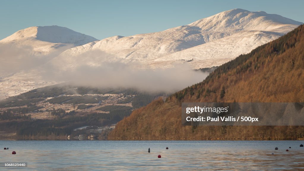 Scenic view of mountains over water