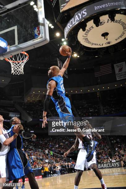 Vince Carter of the Orlando Magic dunks against Anthony Morrow of the New Jersey Nets during the game on November 13, 2010 at the Prudential Center...