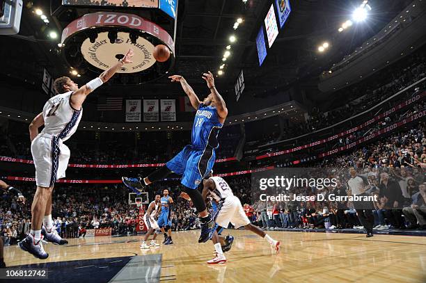 Jameer Nelson of the Orlando Magic takes the game-winning shot against Brook Lopez of the New Jersey Nets during the game on November 13, 2010 at the...