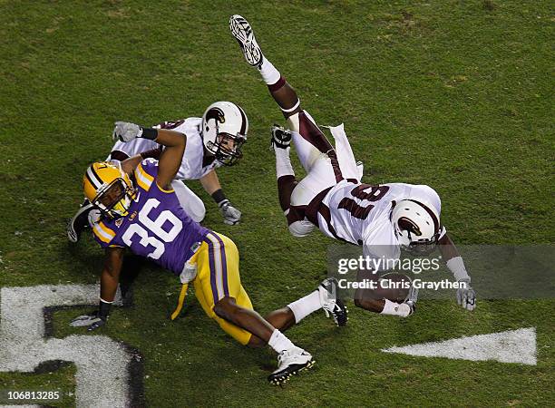 Tavarese Maye of the University of Louisiana-Monroe Warhawks is flipped by Derrick Bryant of the Louisiana State University Tigers at Tiger Stadium...