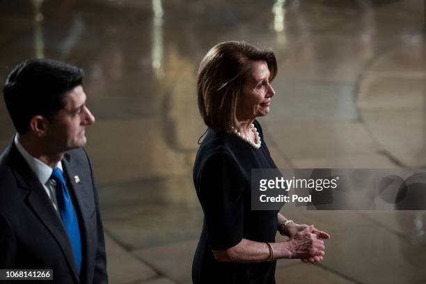 Speaker of the House Rep. Paul Ryan and U.S. House Minority Leader Rep. Nancy Pelosi walk away after paying their respects to former U.S. President...