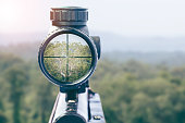 rifle target view on Natural Background. Image of a rifle scope sight used for aiming with a weapon