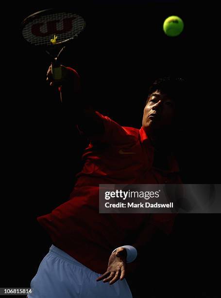 Wu di of China hits a smash in the Men's Team Tennis Quarterfinal match against Tatsuma Ito of Japan at the Aoti Tennis Centre during day two of the...