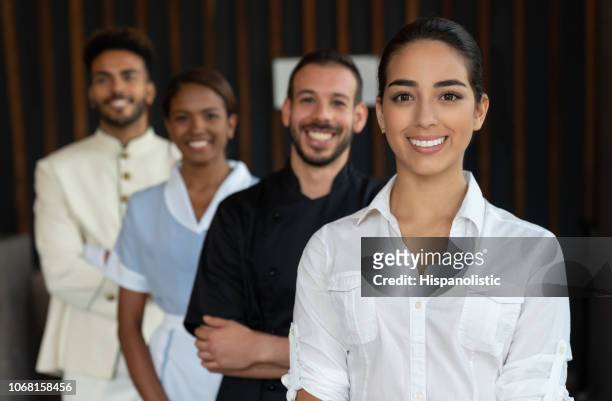 beautiful female manager and her team standing behind all looking at camera smiling - cleaner man uniform stock pictures, royalty-free photos & images