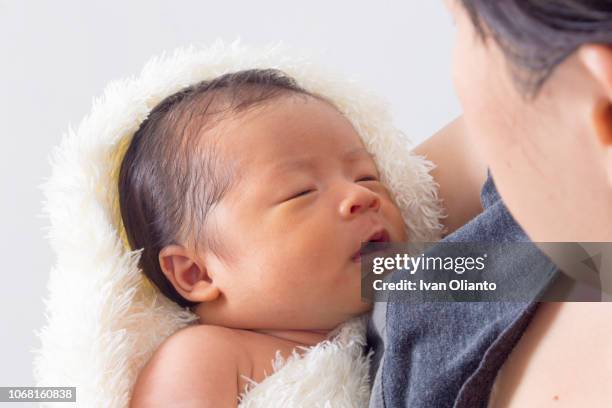 asian woman carrying her baby - tired mother stock pictures, royalty-free photos & images