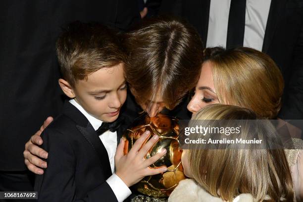 Luka Modric of Croatia and Real Madrid kiss the trophy with his wife Vanja Bosnic and their children Ivano and Ema after he won the 2018 Ballon D'Or...