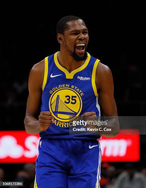 Kevin Durant of the Golden State Warriors reacts after hitting a three-point basket against the Atlanta Hawks at State Farm Arena on December 3, 2018...