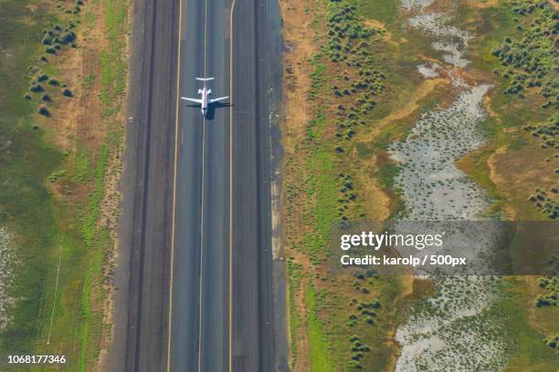 aerial view of airplane on runway - airport above stock-fotos und bilder