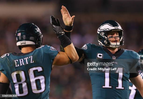 Tight end Zach Ertz high-fives teammate quarterback Carson Wentz of the Philadelphia Eagles after a catch for a first down against the Washington...
