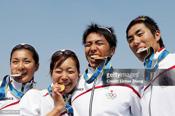 Japan's Triathlon medallists Akane Tsuchihashi ,Mariko Adachi , Yuichi Hosoda and Ryosuke Yamaoto pose with their medals at the Triathlon Venue...
