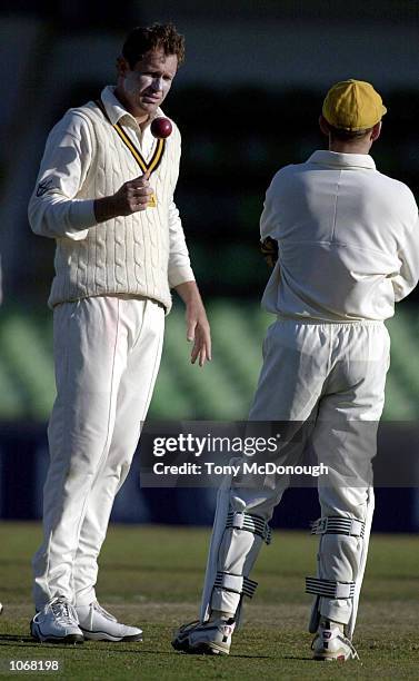 Tom Moody, captain for Western Australia, discusses tactics with Adam Gilchrist during the first days playin the Pura Cup against Queensland at the...