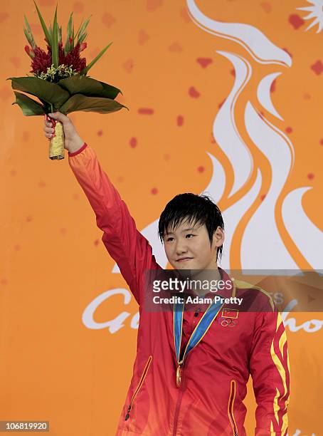 Shi Wen Ye of China poses with the gold medal won in the Women's 400m Individual Relay Medley final at the Aoti Aquatics Centre during day two of the...