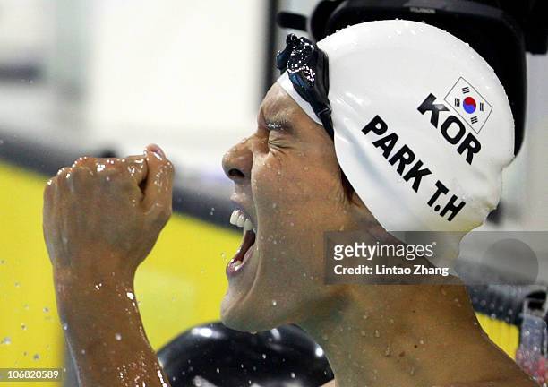 Taehwan Park of South Korea celebrates after winning the gold medal in the Men's 200m Freestyle final at the Aoti Aquatics Centre during day two of...