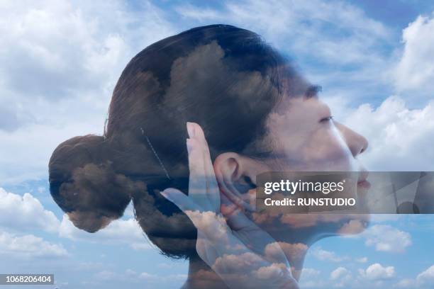 woman trying to ear - ear listening stock pictures, royalty-free photos & images