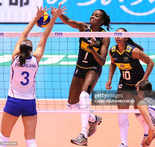 Brazil's captain Fabiana Claudino spikes the ball over Russia's Maria Perepelkina during their final match at the world women's volleyball...