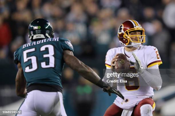 Quarterback Mark Sanchez of the Washington Redskins looks to pass against linebacker Nigel Bradham of the Philadelphia Eagles during the second...