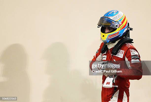 Fernando Alonso of Spain and Ferrari walks in parc ferme following the Abu Dhabi Formula One Grand Prix at the Yas Marina Circuit on November 14,...