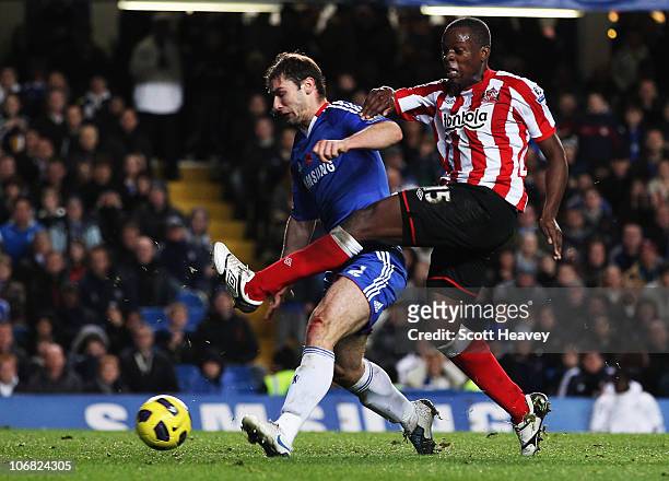 Nedum Onuoha of Sunderland beats Branislav Ivanovic of Chelsea to score their first goal during the Barclays Premier League match between Chelsea and...