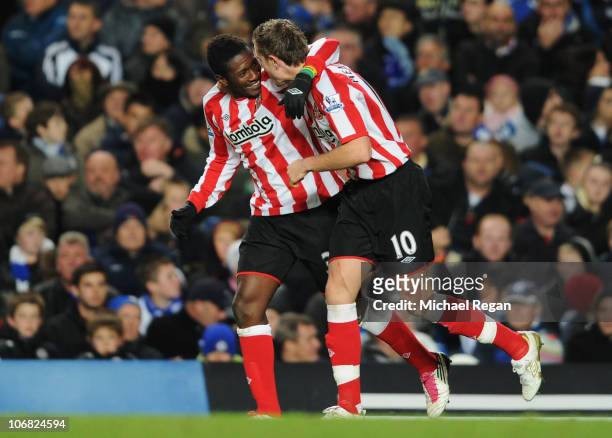 Asamoah Gyan of Sunderland celebrates with Jordan Henderson as he scores their second goal during the Barclays Premier League match between Chelsea...