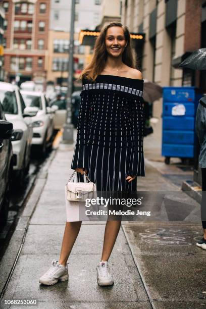 Model Michelle Gutknecht wears a Prabal Gurung dress, tan Proenza Schouler purse, and white Fila sneakeres after the Brock Collection show during New...