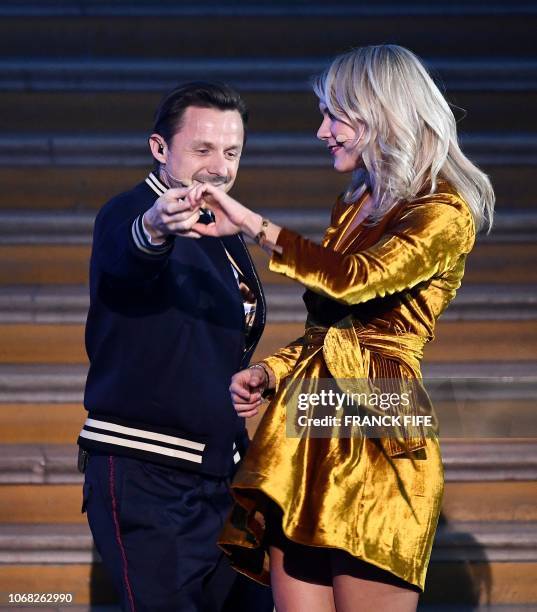 Olympique Lyonnais' Norwegian forward Ada Hegerberg dances with French DJ and producer Martin Solveig after receiving the 2018 Women's Ballon d'Or...