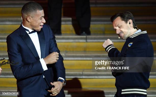 French DJ and co-host Martin Solveig speaks with French forward Kylian Mbappe during the 2018 Ballon d'Or award ceremony at the Grand Palais in Paris...