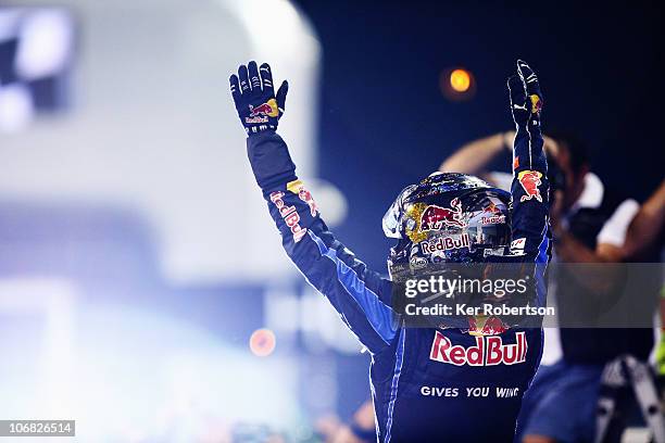 Race winner and F1 2010 World Champion Sebastian Vettel of Germany and Red Bull Racing celebrates in parc ferme following the Abu Dhabi Formula One...