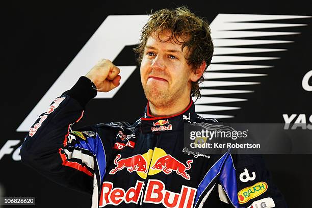 Race winner and F1 2010 World Champion Sebastian Vettel of Germany and Red Bull Racing celebrates on the podium following the Abu Dhabi Formula One...