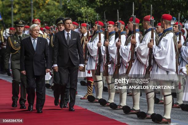 Greek President Prokopis Pavlopoulos and his Slovenian counterpart Borut Pahor review the Greek Presidential guard before their meeting in Athens on...