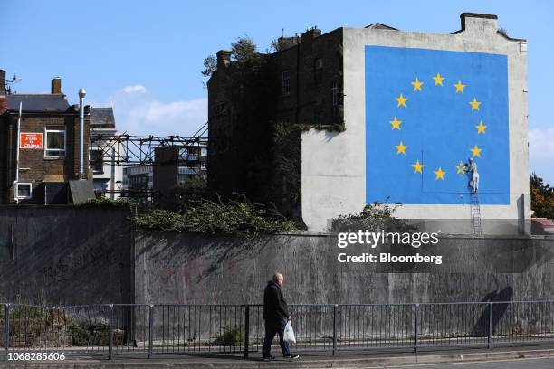 Mural by street artist Banksy depicting a European Union flag being chiseled by a workman covers the side of a building in Dover, U.K., on Friday,...