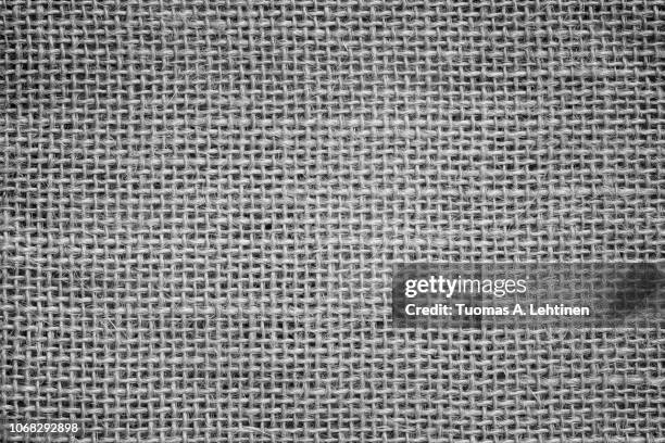 close-up of a burlap jute canvas full frame background with vignetting in black and white. - jute stock-fotos und bilder