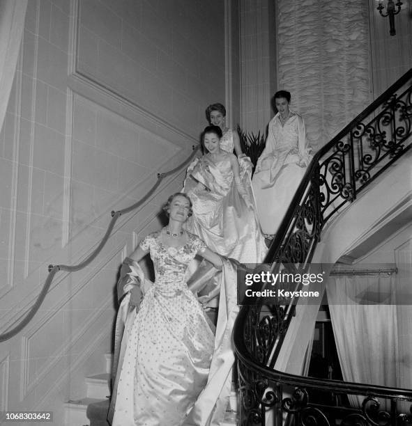 Group of models wearing Christian Dior evening gowns at the Dior Salon in Paris, 17th October 1954. They are taking part in a preview of a charity...