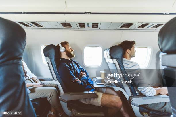 männlichen passagier während des fluges ein nickerchen - flugzeug schlafen stock-fotos und bilder