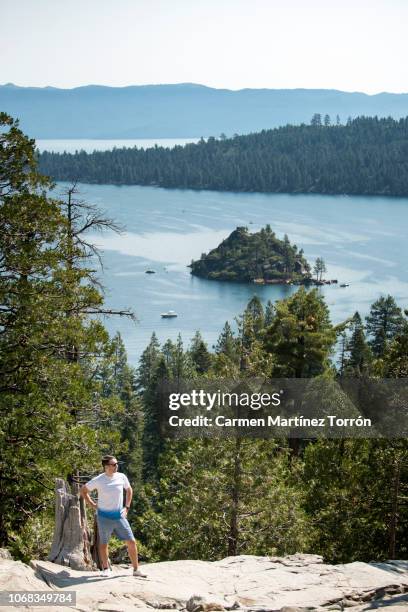 man hiking in emerald bay with incredible lake tahoe views. - emerald bay lake tahoe stock pictures, royalty-free photos & images