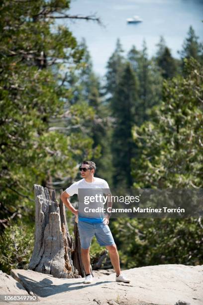 man hiking in emerald bay with incredible lake tahoe views. - emerald bay lake tahoe stock pictures, royalty-free photos & images