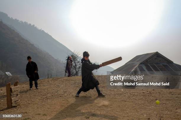 Kashmiri kids play cricket near their house on December 4, 2018 in Srinagar. Almost 96 percent of the population of the Kashmir valley are Muslim.