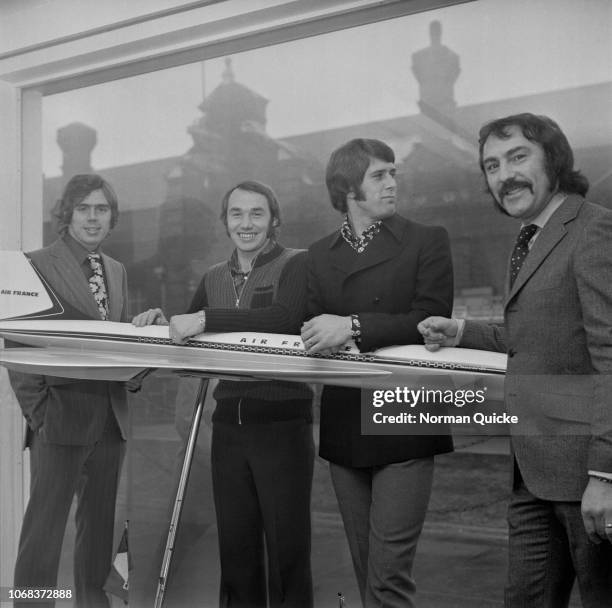 British soccer players Harry Rednapp, Bryan Robson, Geoff Hurst, and Jimmy Greaves signing autographs for fans at the East Ham Travel Agency, agency...