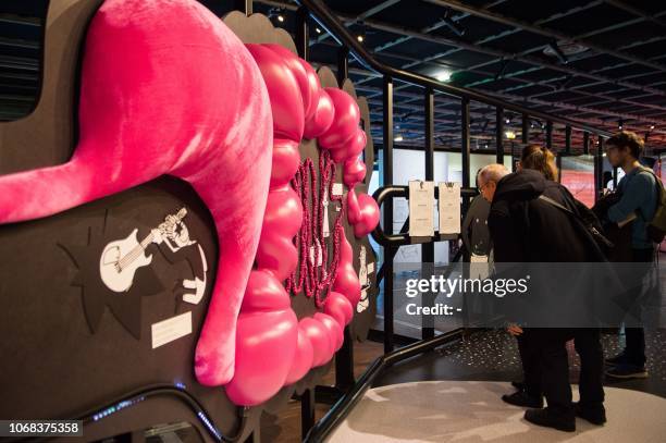 People look at a board as they visit the exhibition entitled "Microbiote" at the "Cite des sciences et de l'industrie" science museum, in Paris, on...