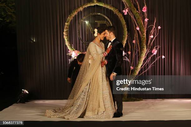 Newly-wed Bollywood actor Priyanka Chopra and American singer Nick Jonas pose for photos during their wedding reception, at Taj Palace on December 4,...