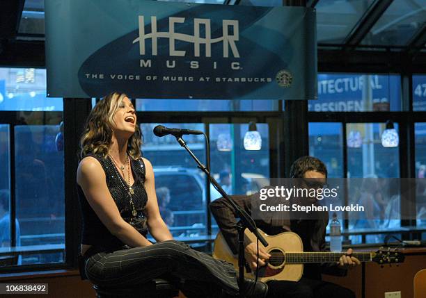 Alanis Morissette and guitarist Jason Orme during Alanis Morissette Starbucks In-Store Performance for the "Jagged Little Pill" 10th Anniversary at...