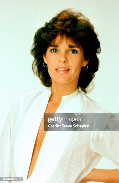 Portrait of American actress Ali MacGraw as she poses, with one hand on her hip, against a white background, Los Angeles, California, 1982.