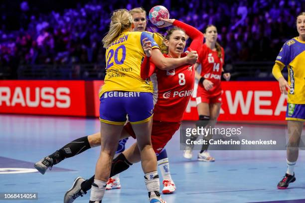 Monika Kobylinska of Poland is shooting the ball against Isabelle Gullden of Sweden during the EHF Women's Euro match between Sweden and Poland on...